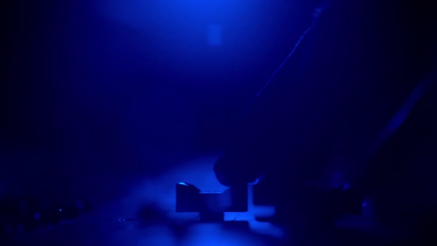 A producer pushes the knob on the sound board