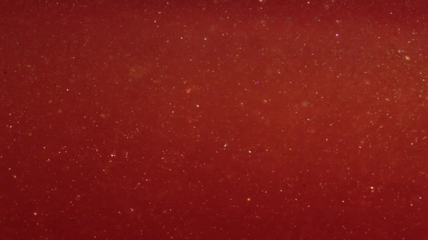 Close up of red liquid with moving glow