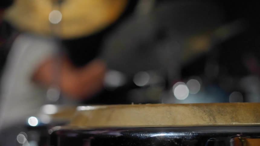 A close up clip of a person drumming