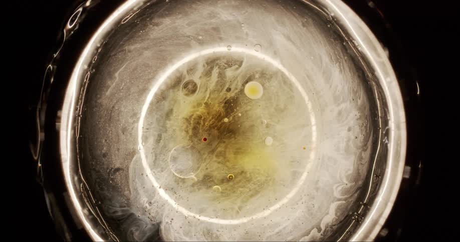 Closeup of a dense abstract liquid in circular motion with illuminated edges