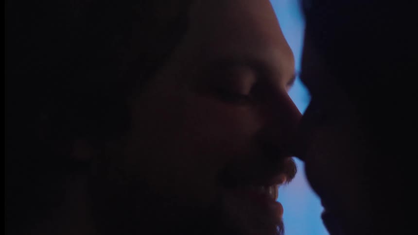 Side portrait of a man and a woman kissing