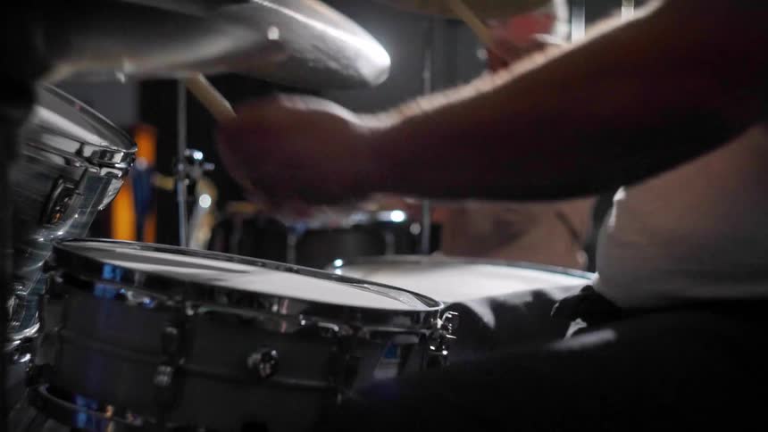 A clip of people playing a drum instrument