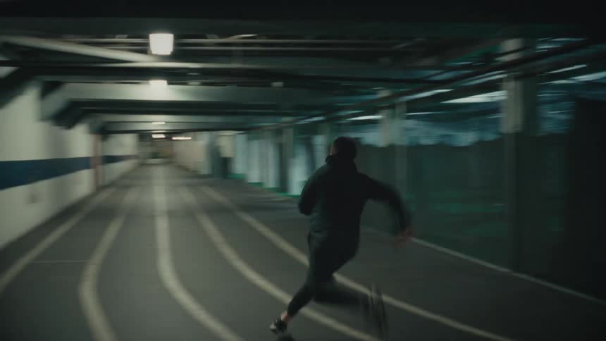 Man running at high speed in an indoor scene of a terminal