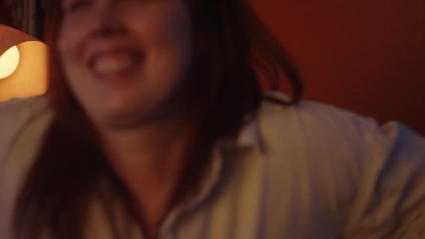 A clip of a female smiling while standing up from her seat