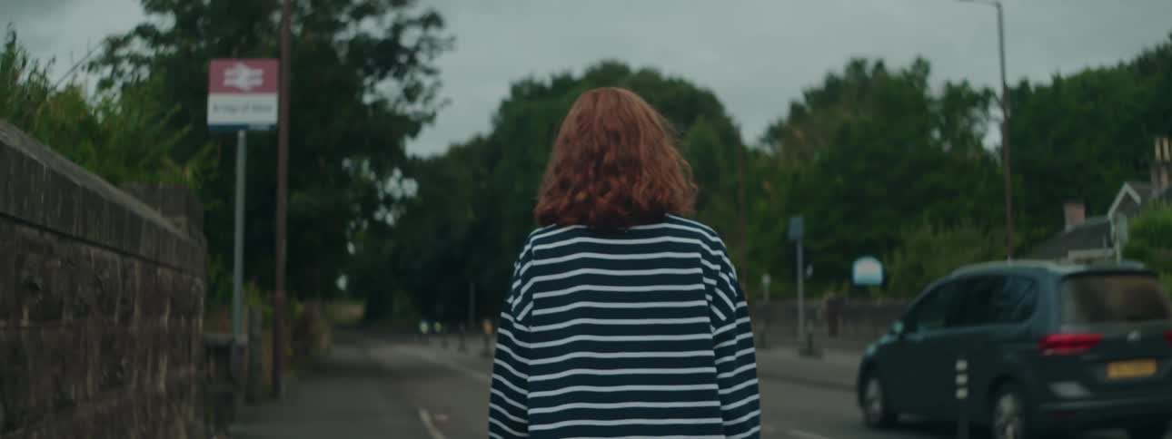 A woman walks down the street