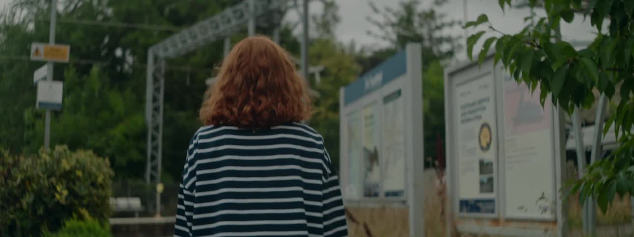 A woman is strolling through a suburban neighborhood in spring