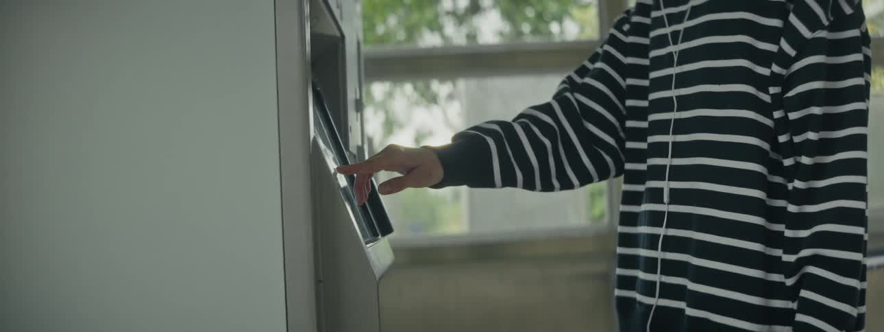 A clip of a person operating a cash machine