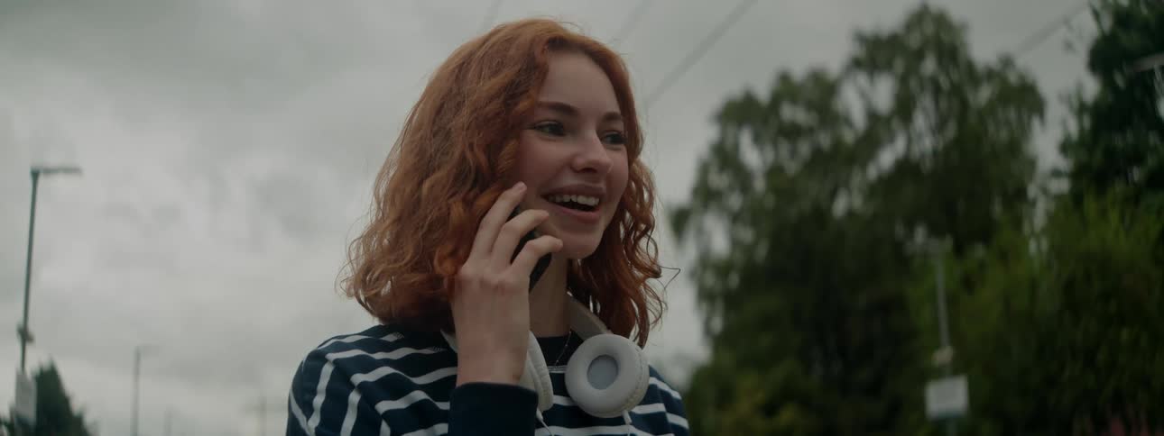 A woman happily talks on the phone