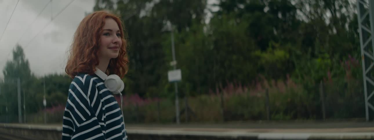 A woman smiles as the train passes