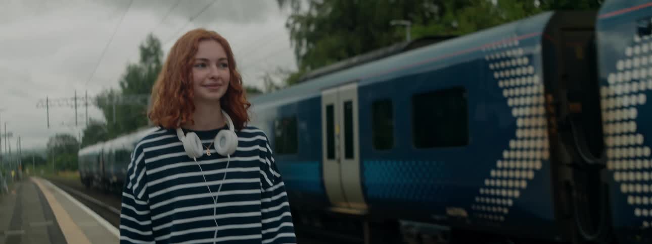 A clip of a lady walking by the rail side