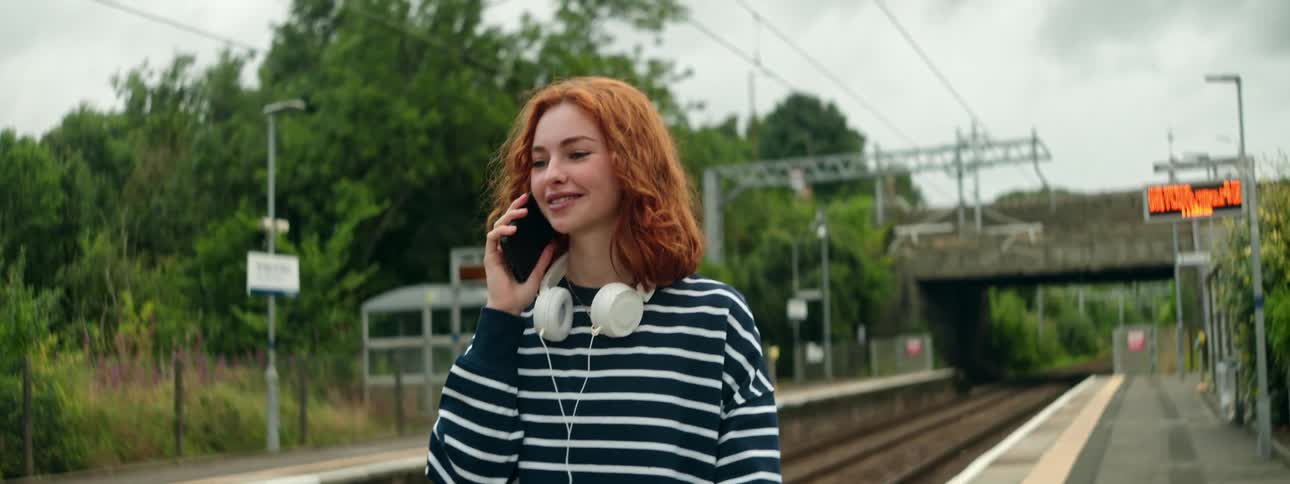 A close up clip of a lady making a phone call while walking at the terminal
