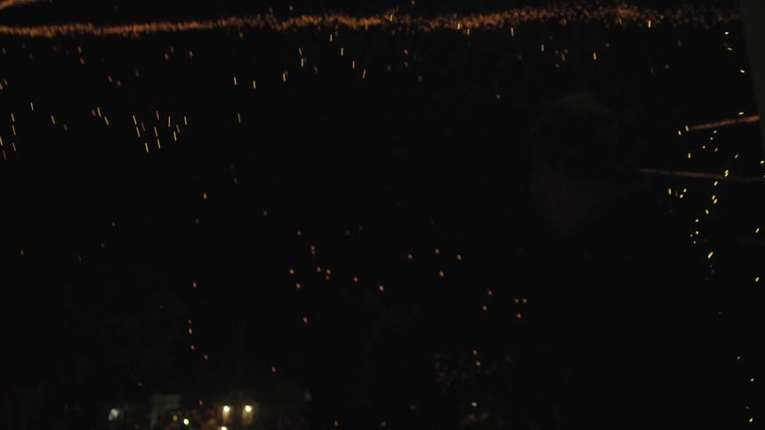 Fireworks streaking across and through a dark sky