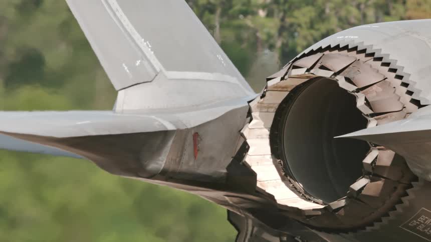 The rear of a fighter jet showing the complex engine nozzle and exhaust system