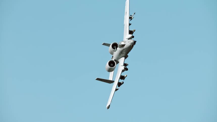 A bomber is turning as it flies in the sky