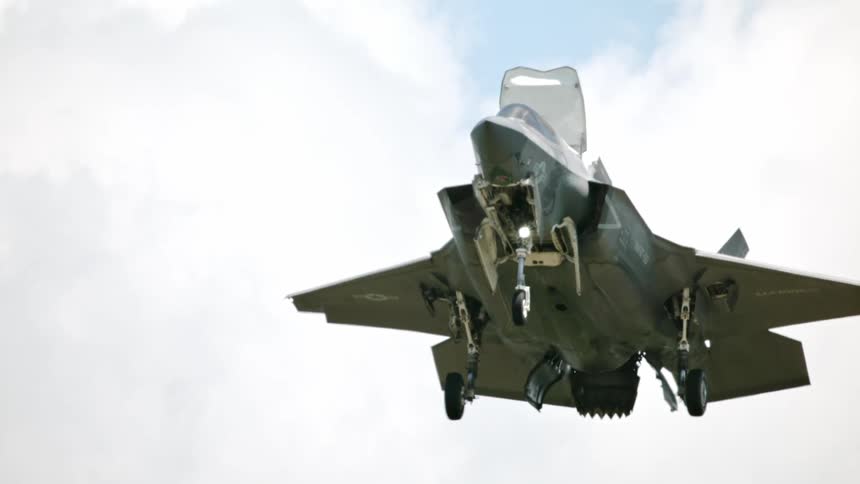 An f35 lightning ii fighter jet descends towards the ground its landing gear extended