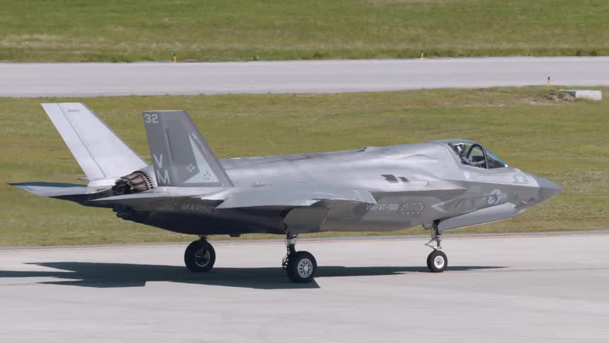 A sleek f35 lightning ii fighter jet taxis on a runway its powerful engines visible