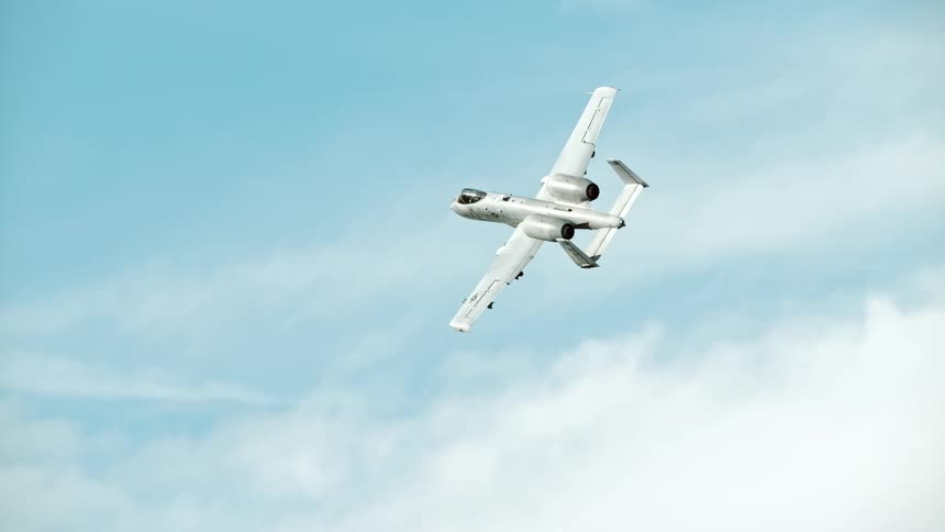 A bomber is flying and turning in the sky