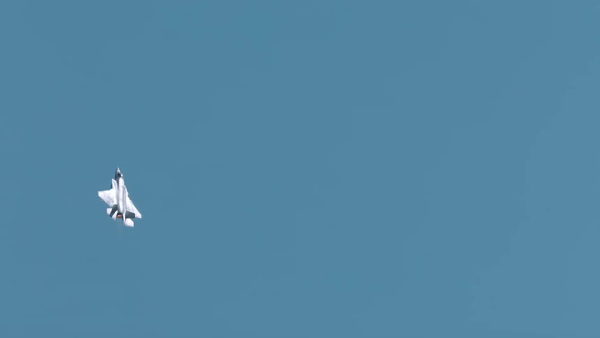 A military aircraft is flying in the sky and moving in different ways