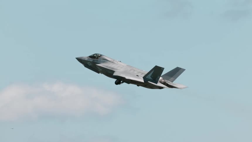 An f 35 lightning ii fighter jet takes off from a runway leaving a trail of smoke behind