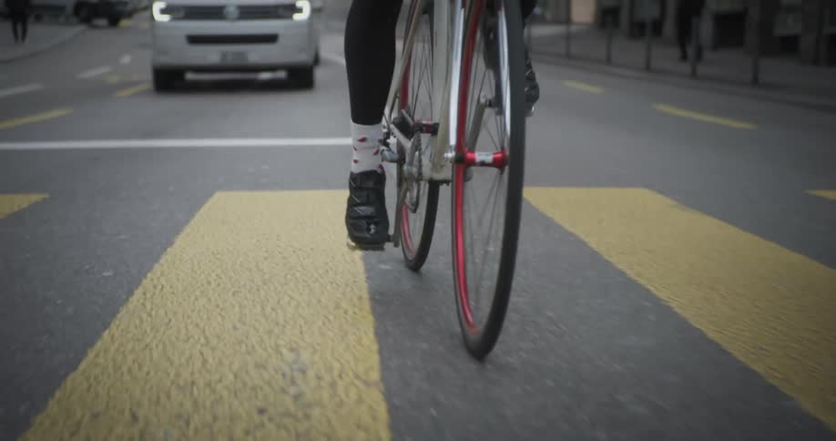 Cyclist riding on an urban road with vehicle traffic