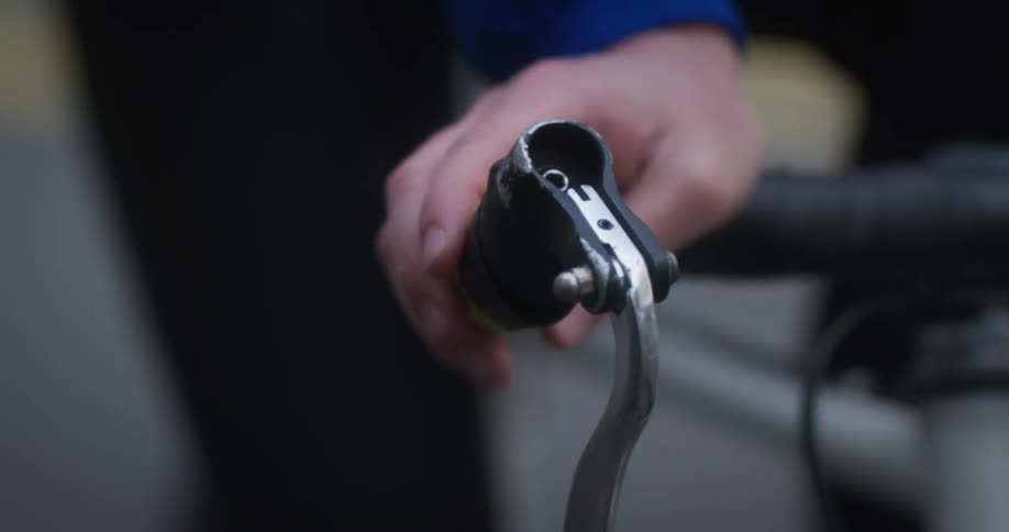 A persons hands gripping the handlebars of a bicycle