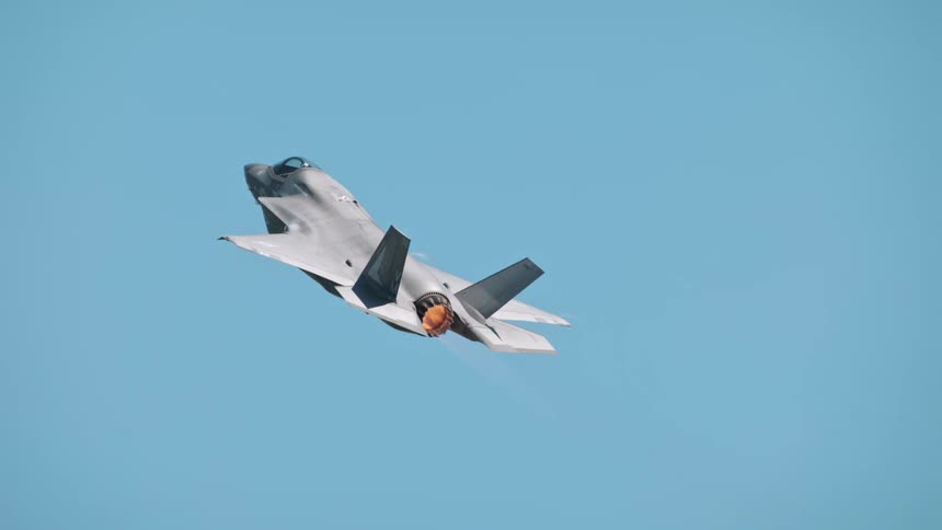 Fighter jet climbing with turbine emitting fire