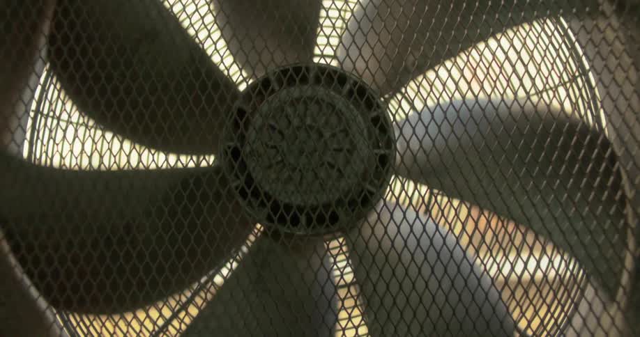 Several metal propellers spinning and in front there is a metal grid
