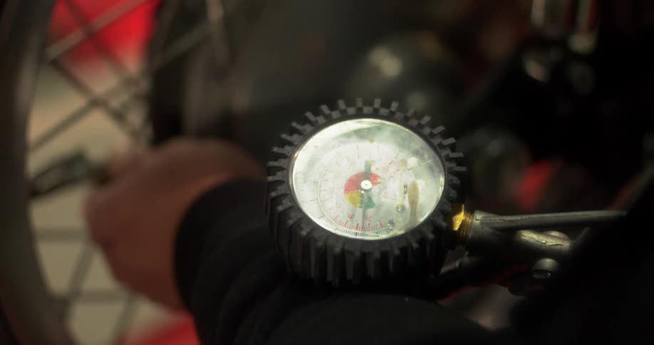 A person is filling the air on their bicycle tire
