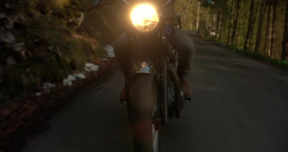 People are riding motorcycles on a mountain trail