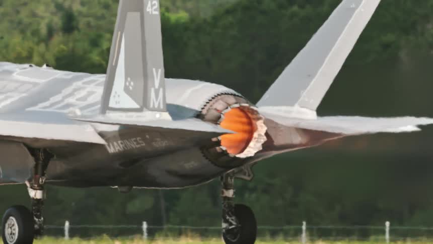 Military fighter jet in full flight with focus on the rear turbine landing