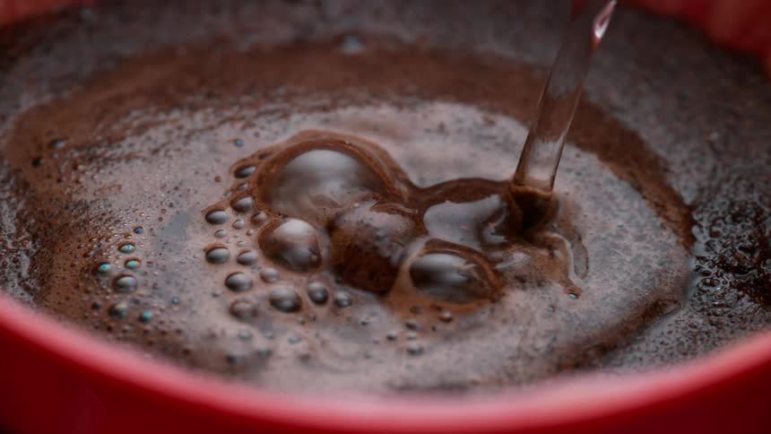 Water being poured into bubbling coffee