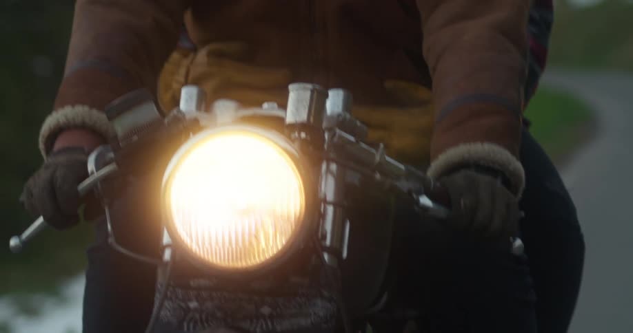 Two people sitting on a moving motorcycle