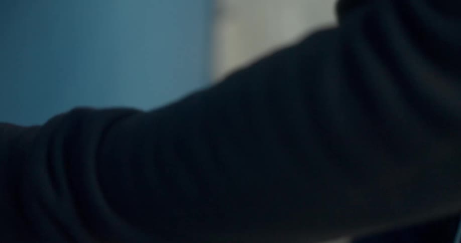 Hand taking a key from pocket and opening a door