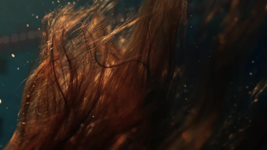 Closeup of a womans hair in a swimming pool
