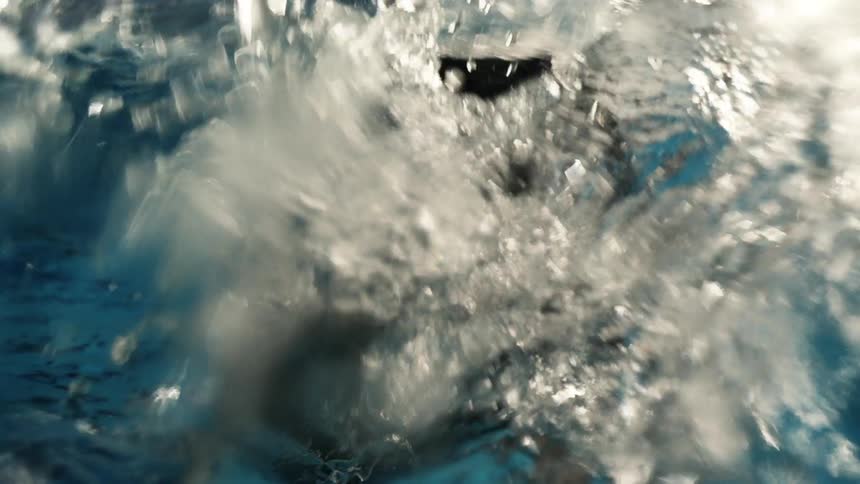Close up of a person swimming in a swimming pool