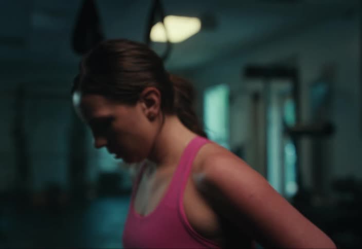 Portrait of a focused woman in a gym environment
