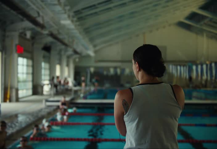 Swimming teacher in a pool leading a class