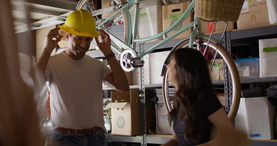 A man tries on a hard hat in the garage
