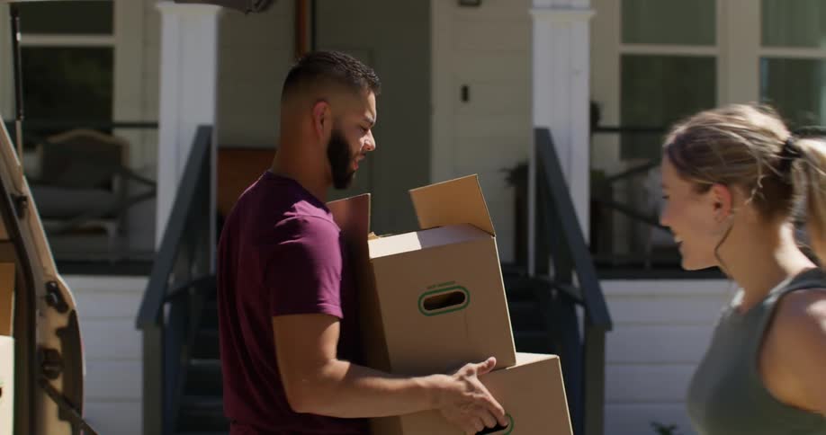 A clip of a male and female packing some boxes