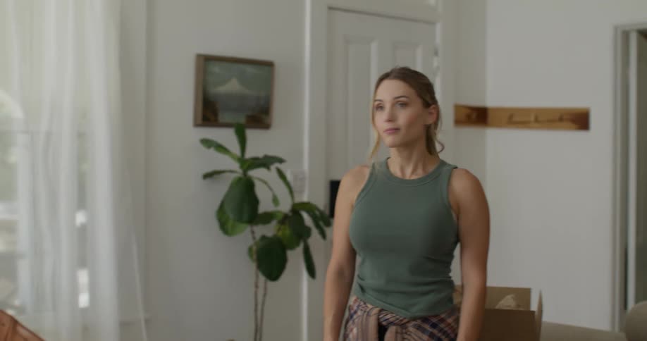 Woman and a man inside a living room looking in the same direction