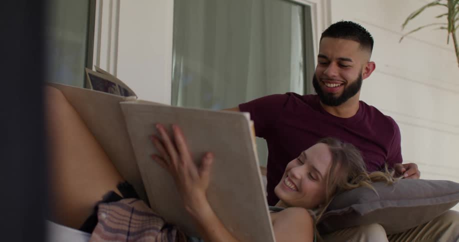 Happy couple together looking at a photo album