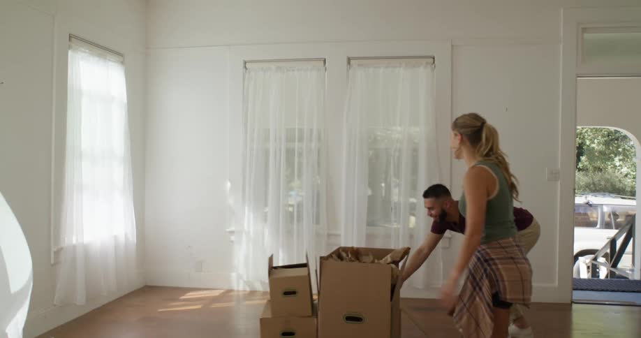 A clip of a male and female packing into a new house