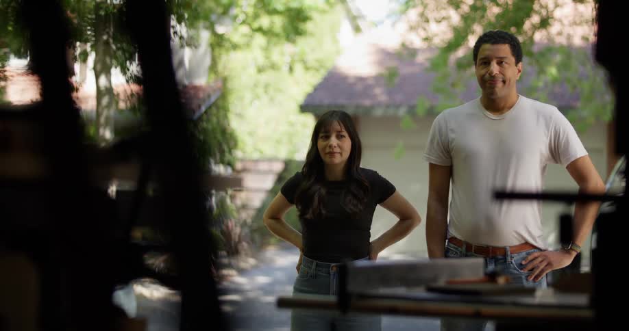 A man and woman stand outside the garage
