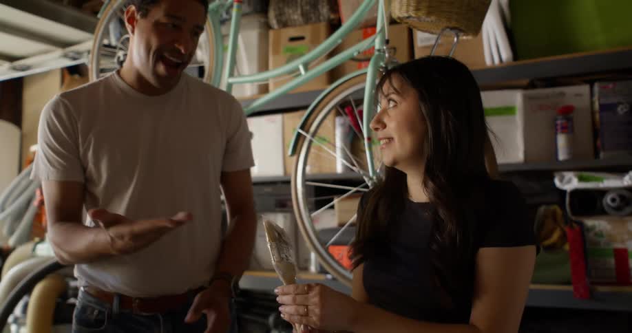 A man and woman search through boxes together
