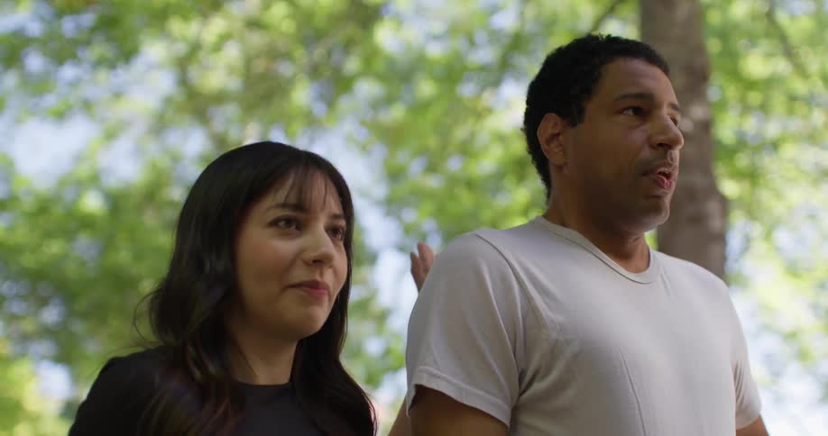 Man taking a deep breath and a woman next to him patting his back