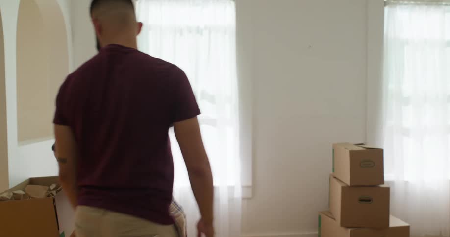A woman carries a box across the room