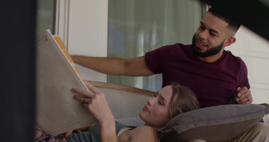 Man sitting with a woman looking at an album
