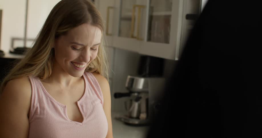 Happy woman talking to another person and wiping her face