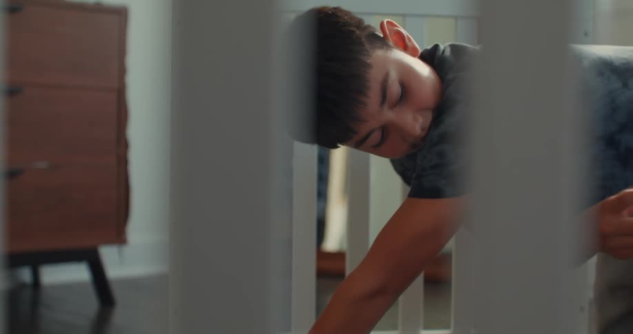 A boy is using a tool to build a crib