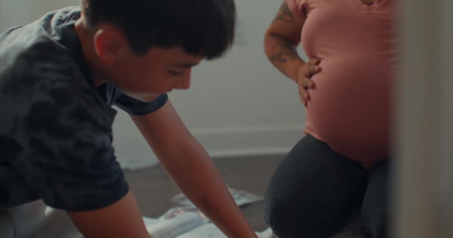 Boy next to a pregnant woman